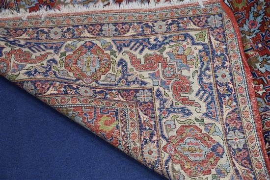 A Persian red ground carpet, 11ft x 7ft 11in.